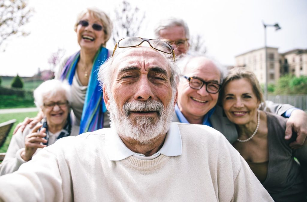 A group of seniors taking a photo while they socialize and build connections with each other