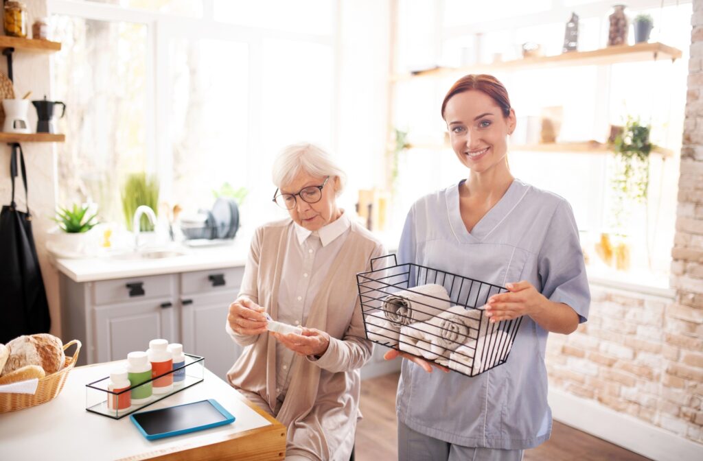 Young female caregiver assists a resident with organizing laundry.