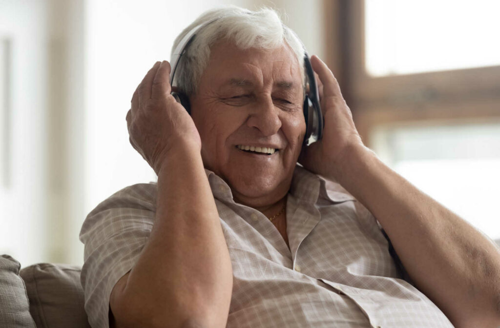 A resident enjoying music while listening through headphones.