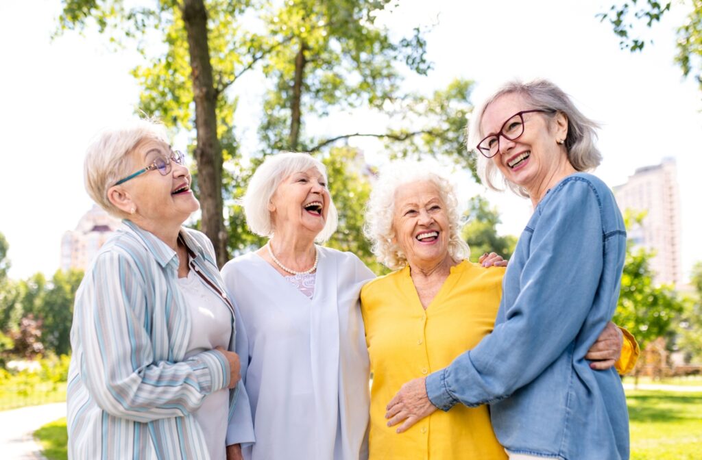 A group of older happy adult women hanging out outdoors.