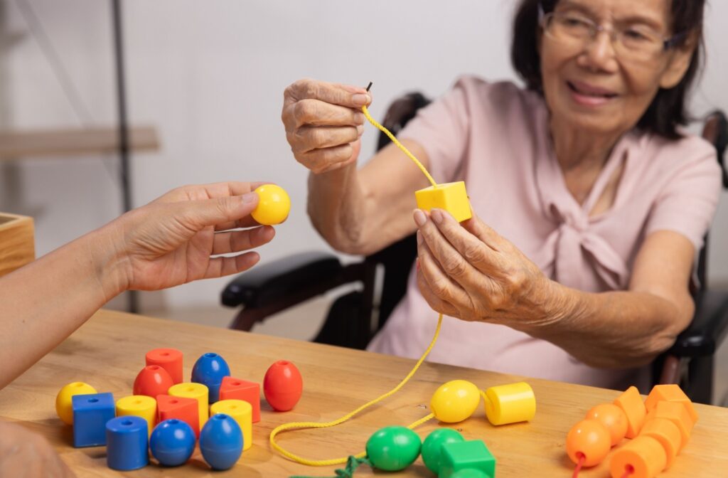 A memory care resident participates in a cognitive puzzle.